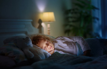child sleeping in dark bedroom